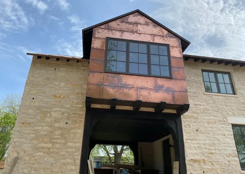 Copper metal panel facade on a stone building for Skylight Installation in Winterville